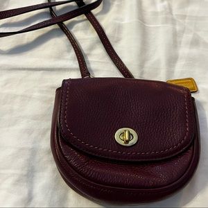 Dark purple small Coach purse.